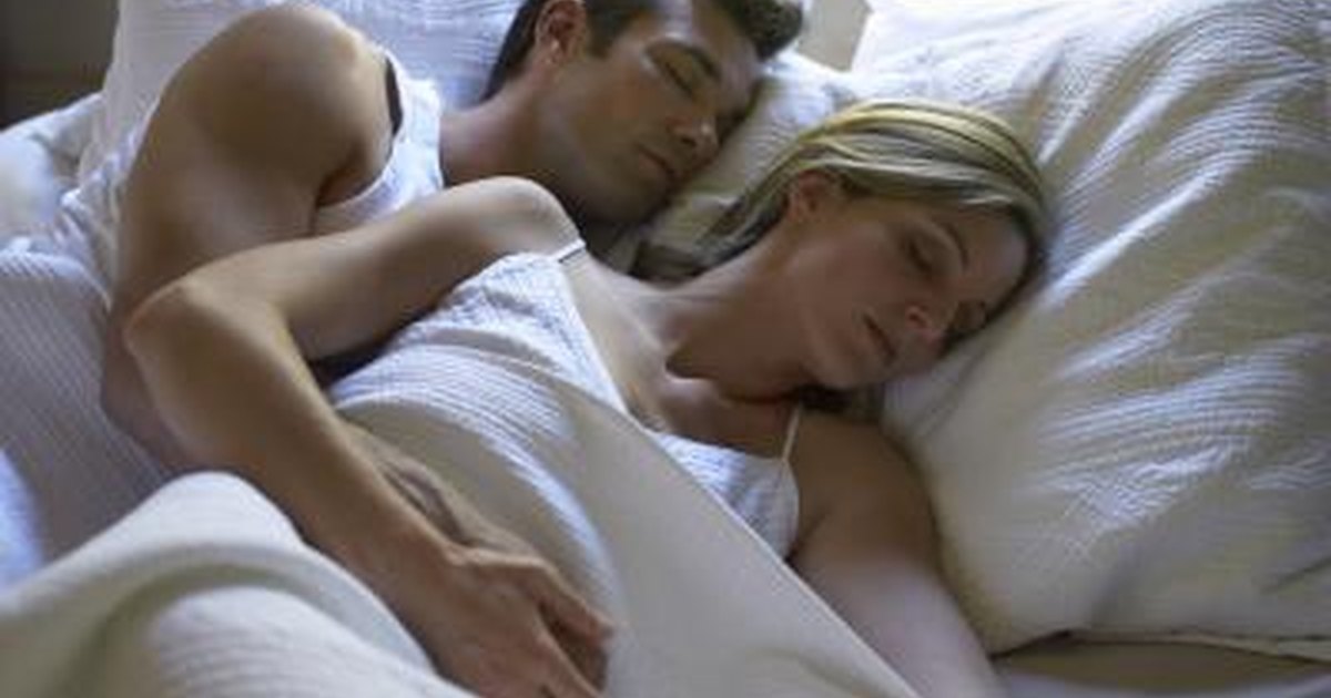 What are some causes of sudden muscle contractions while sleeping?